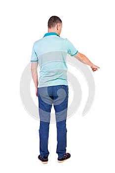 Back view of pointing young men in shirt and jeans.