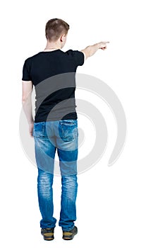 Back view of pointing young men in shirt and jeans. Young guy