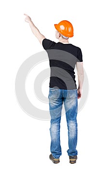 Back view of pointing young men in t-shirt and helmet.