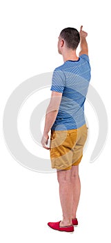 Back view of pointing young men in t-shirt and shorts.