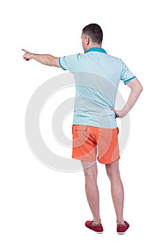 Back view of pointing young men in t-shirt and shorts.