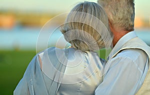 Back view. Portrait of happy elderly couple resting
