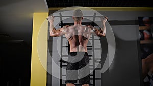 Back view portrait of a muscular man tightening in The Gym's Studio