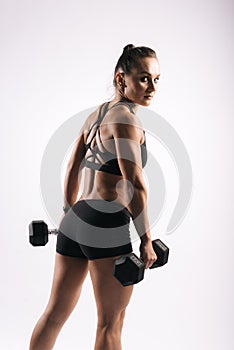 Back view portrait of muscular sexy young woman in black sportswear