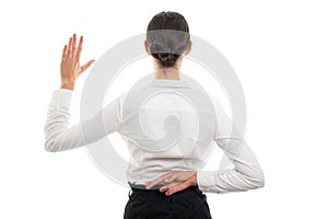 Back view of pretty bussines woman showing fake oath gesture photo