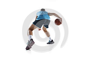 Back view of professional basketball player in blue sports uniform training isolated on white studio background.