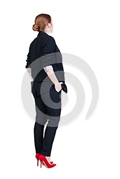 Back view of redhead business woman contemplating.