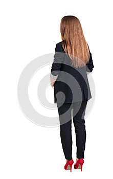 Back view of redhead business woman contemplating.