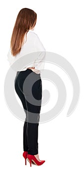 Back view of redhead business woman contemplating.