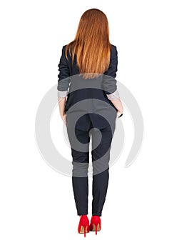 Back view of redhead business woman contemplating.