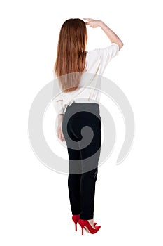 Back view of redhead business woman contemplating.