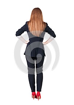 Back view of redhead business woman contemplating.