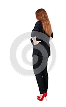 Back view of redhead business woman contemplating.