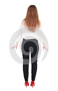 Back view of redhead business woman contemplating.