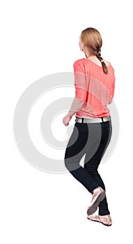 Back view of running woman in jeans