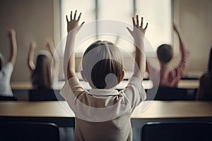 Back view of schoolboy raising hands in classroom. Back view of schoolboy raising hands in classroom. Little students full rear