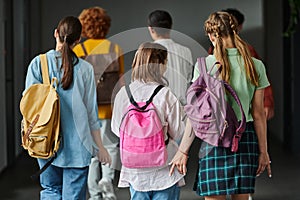 back view of schoolkids walking in