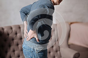 Back view of senior man with backache