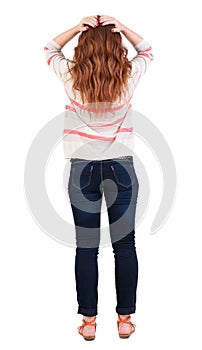 Back view of shocked redhead woman