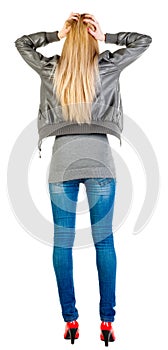 Back view of shocked woman in gray jacket