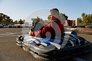 Back view shot of competitive racer driving go-cart sports track