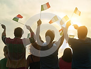 Back view, silhouette of italian people with flags.