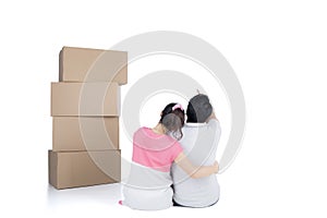 Back view of sitting cute couple with stack of cardboard boxes