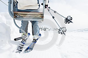 Back view of skier riding a lift.