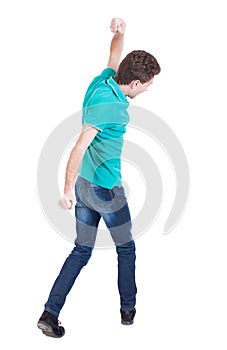 Back view of skinny guy funny fights waving his arms and legs.