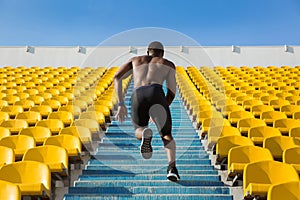 Back view of a sportsman doing speed exercise for muscles