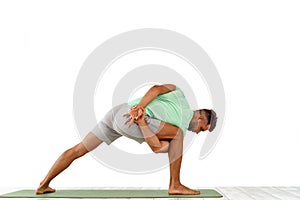 back view of sporty man practicing yoga in yoga class, making stretching back. Healthy lifestyle, Yoga Practice Exercise