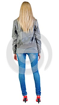 Back view of standing beautiful blonde woman in jacket