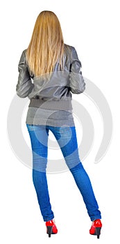 Back view of standing beautiful blonde Young woman.