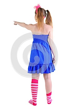 Back view of standing beautiful red haired teenager pointing