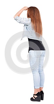 Back view of standing beautiful red head woman.