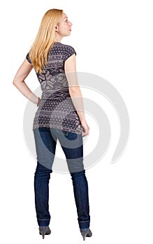 Back view of standing beautiful smiling blonde woman