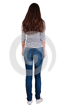 Back view of standing brunette woman.