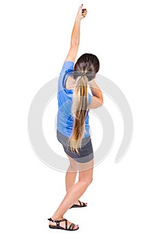 Back view of standing girl pulling a rope from the top or cling