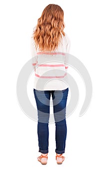 Back view of standing redhead woman