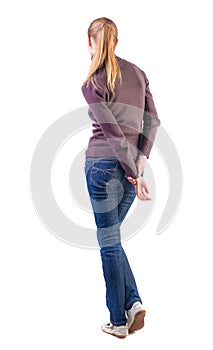 Back view of standing young beautiful blonde woman
