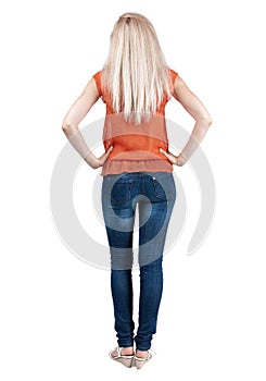 Back view of standing young beautiful blonde woman.