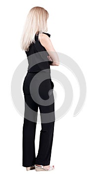Back view of standing young beautiful blonde woman.