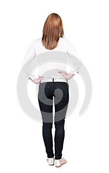 Back view of standing young beautiful brunette woman.