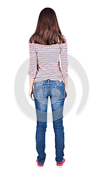 Back view of standing young beautiful brunette woman.