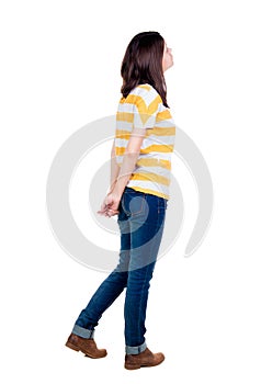 Back view of standing young beautiful brunette woman