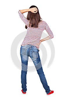 Back view of standing young beautiful brunette woman.