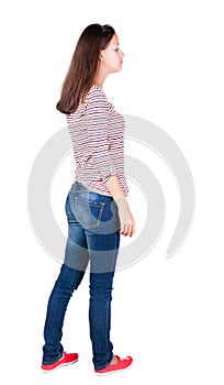 Back view of standing young beautiful brunette woman.