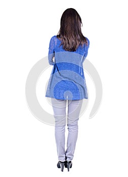 Back view of standing young beautiful brunette woman.