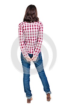 Back view of standing young beautiful brunette woman in checker