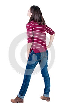 Back view of standing young beautiful brunette woman in red pul